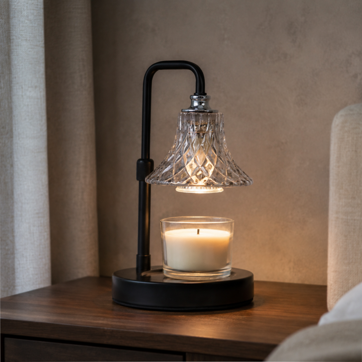 Vintage glass candle warmer glowing on a dark wooden nightstand beside a bed in a warm interior.
