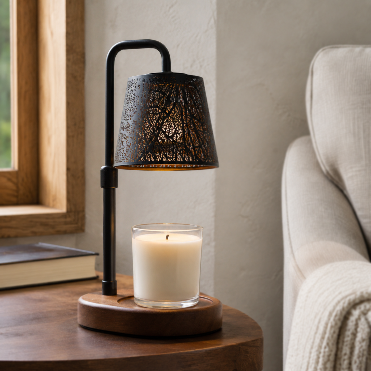Woodland candle warmer displayed on a round wooden side table beside a cream armchair and window.