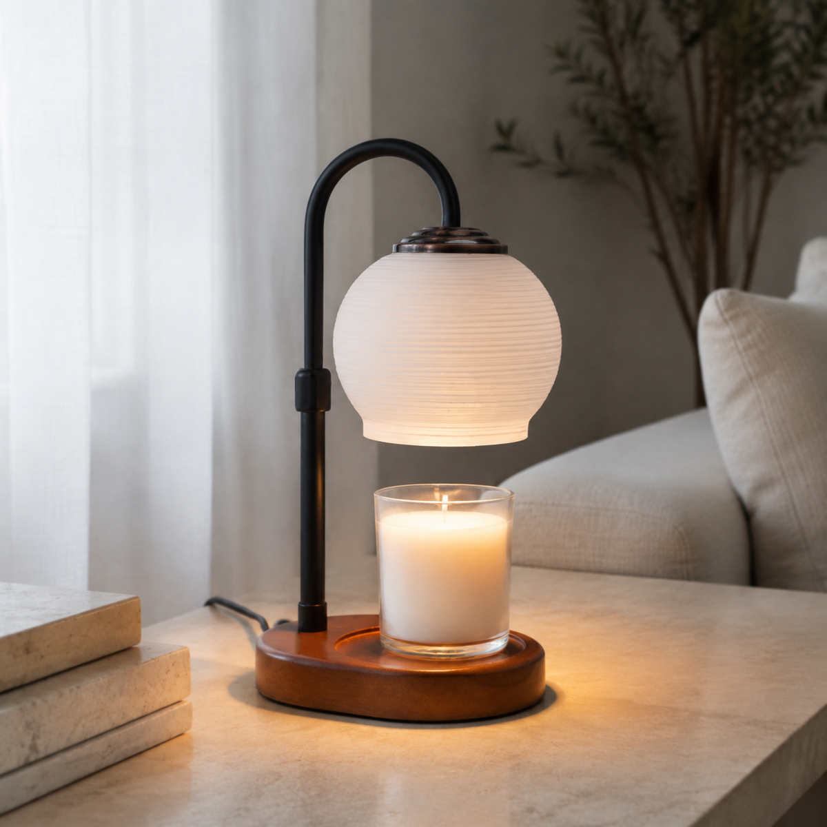 Textured Sphere candle warmer lamp glowing on a pale stone table beside a neutral sofa.