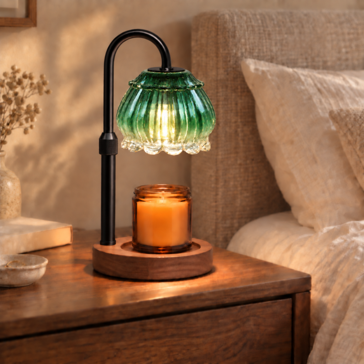 Emerald green candle warmer lamp with walnut base and black arm on a bedroom bedside table
