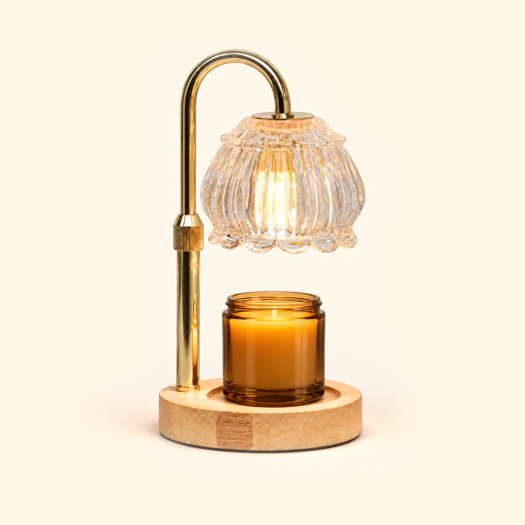Clear glass candle warmer lamp warming an amber jar candle on a warm cream background