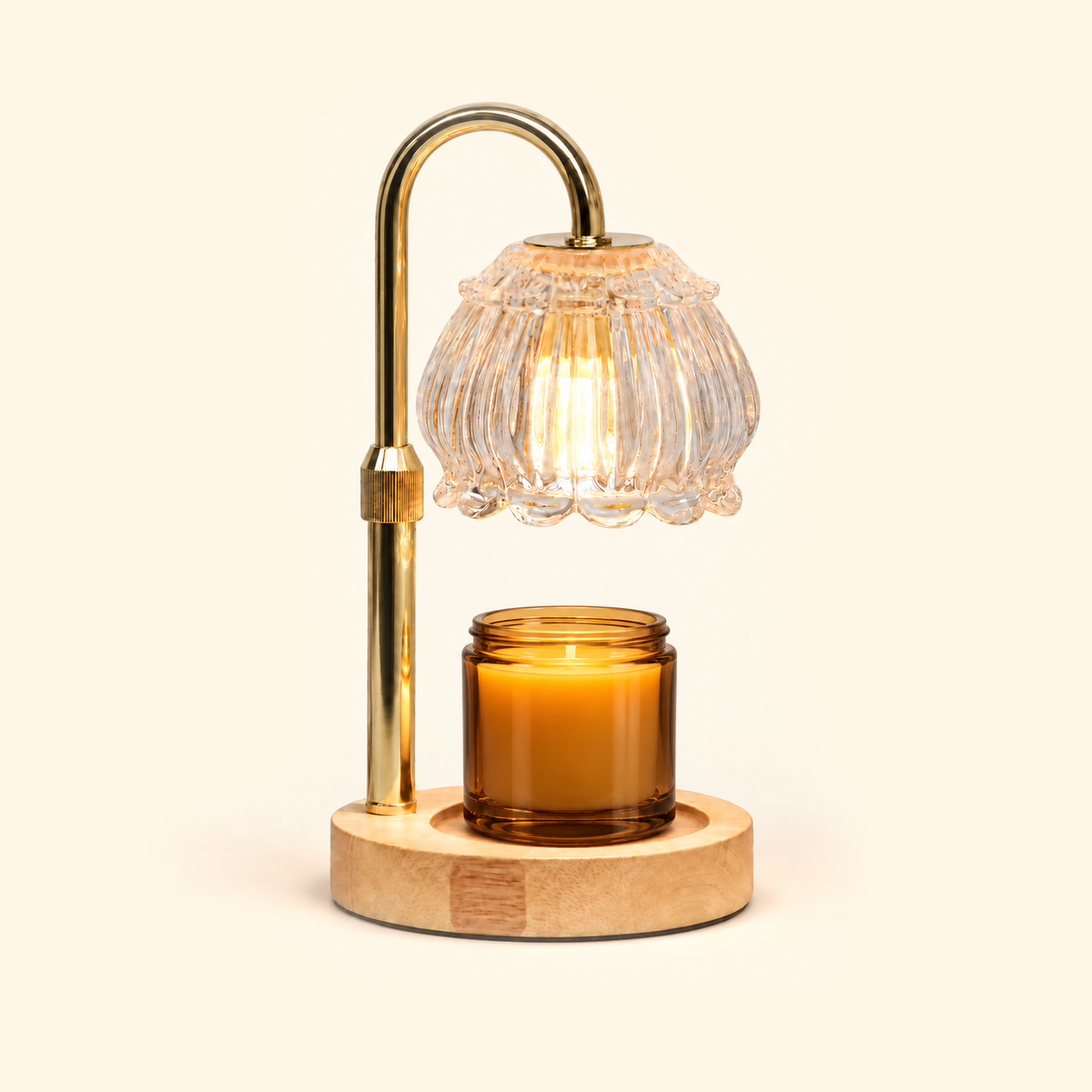 Clear glass candle warmer lamp warming an amber jar candle on a warm cream background