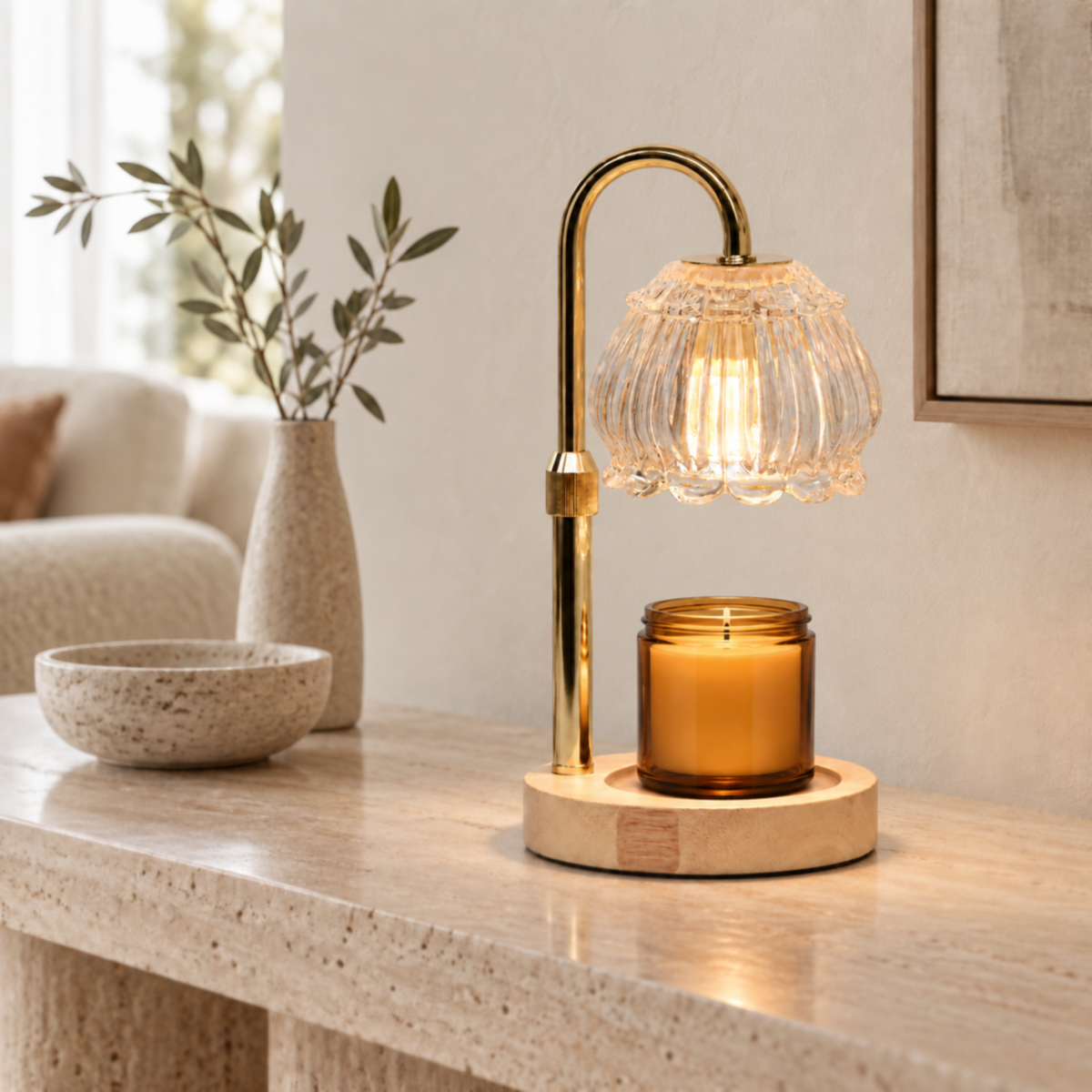 Clear glass candle warmer lamp warming an amber jar candle on a neutral living room console