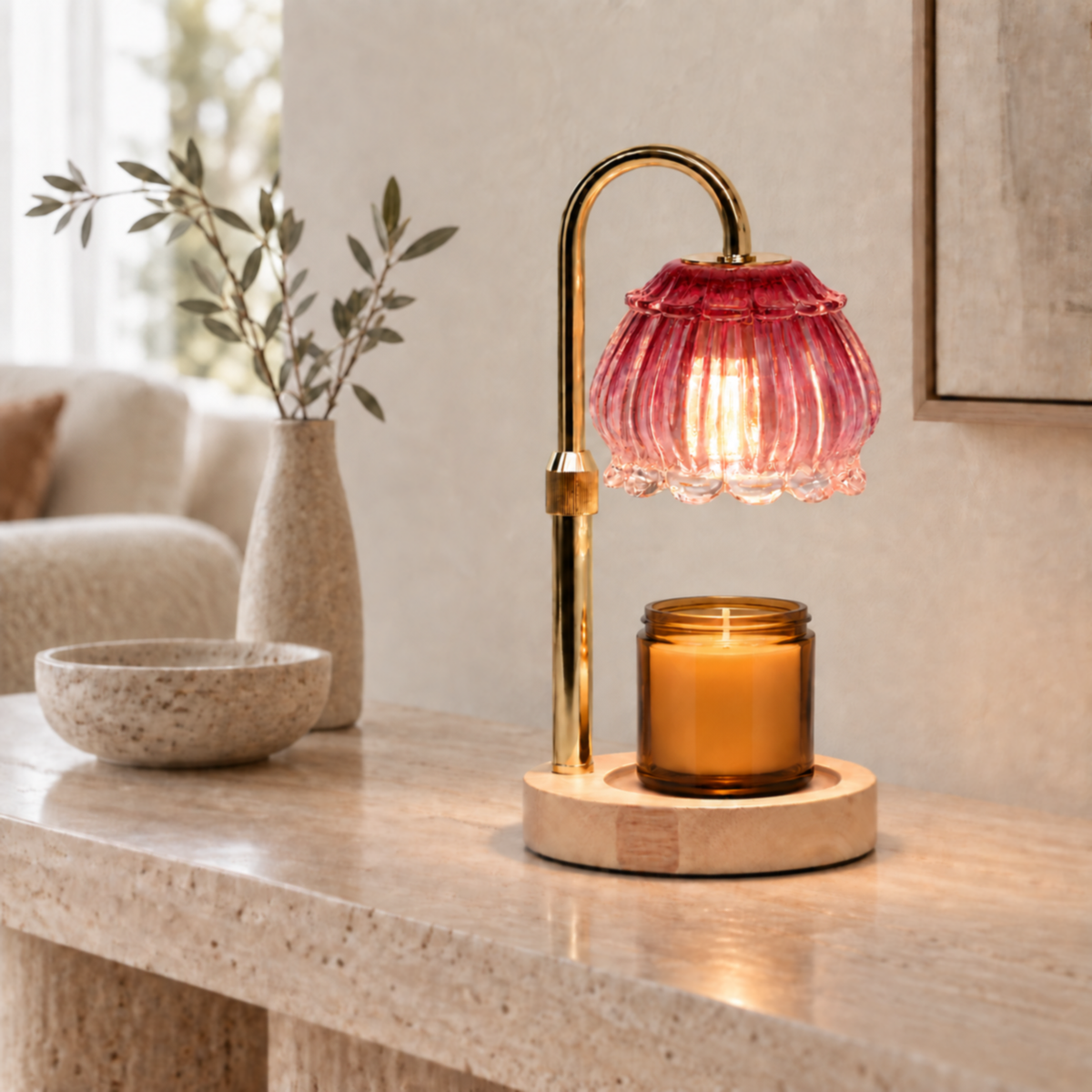 Ruby red glass candle warmer lamp warming an amber jar candle on a living room console