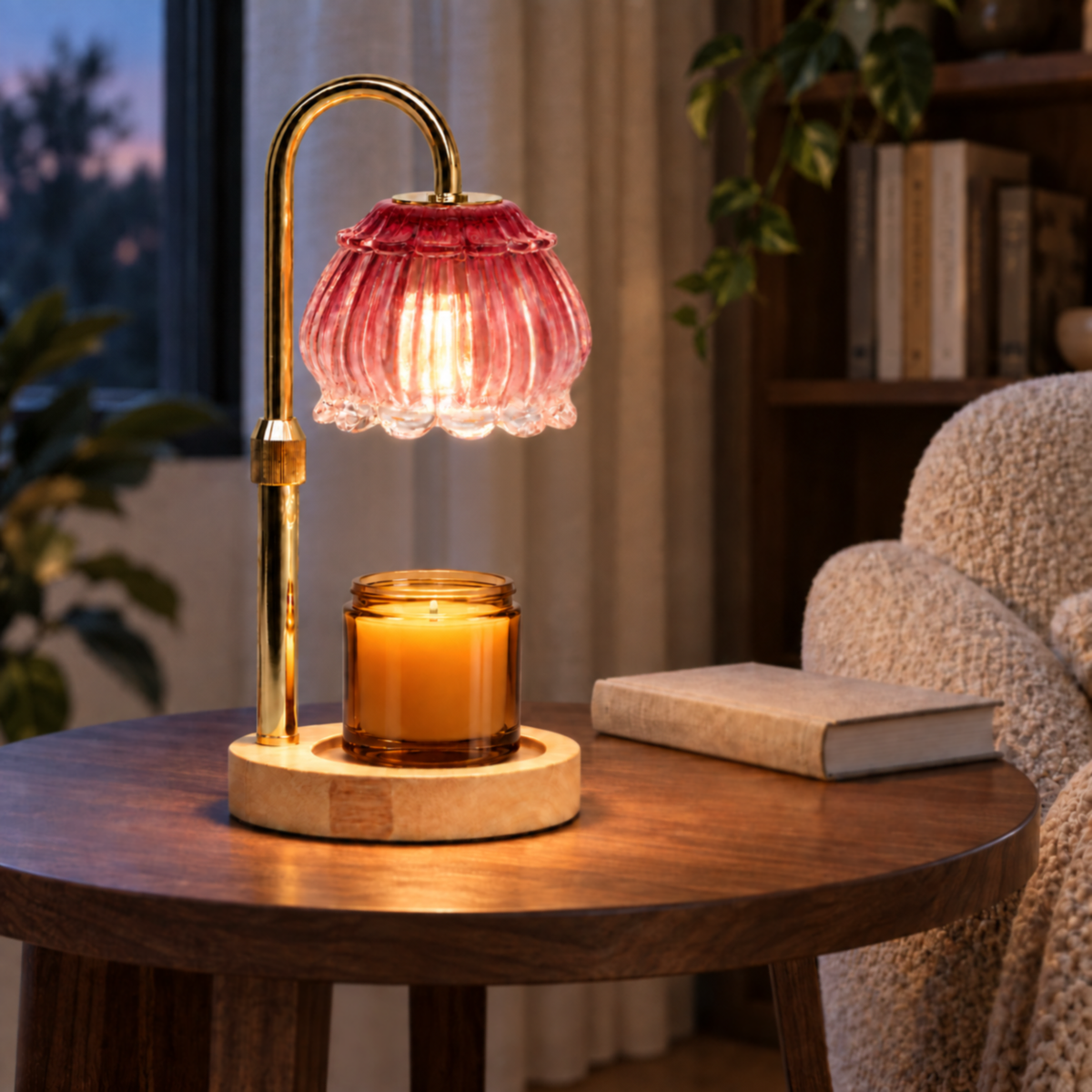Ruby red candle warmer lamp with raised shade displayed in a cozy reading corner