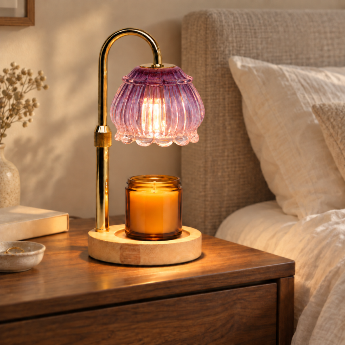 Amethyst purple candle warmer lamp with gold arm displayed on a bedroom bedside table
