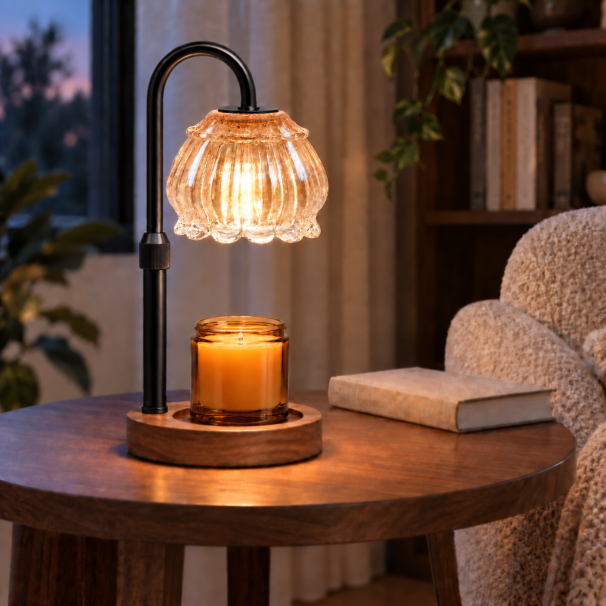 Champagne candle warmer lamp with black arm and raised shade in a cozy reading corner