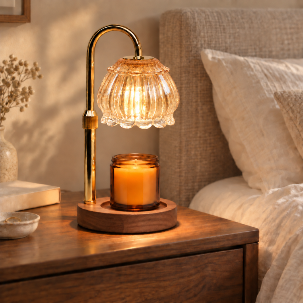 Champagne fluted glass candle warmer lamp with walnut base on a bedroom bedside table