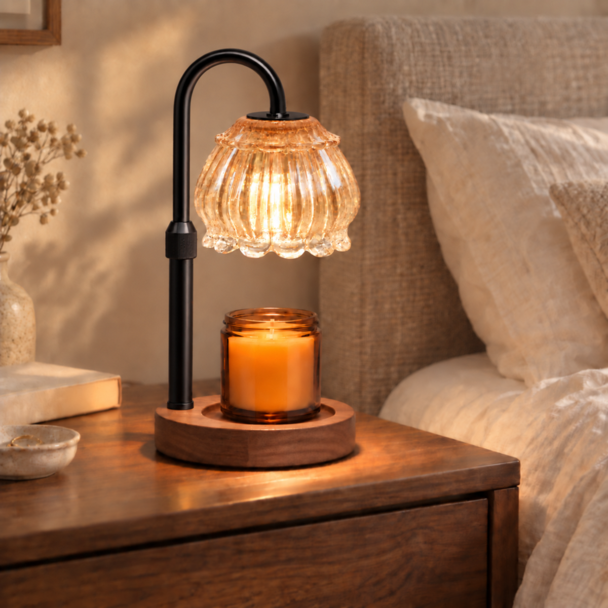 Champagne candle warmer lamp with walnut base and black arm on a bedroom bedside table