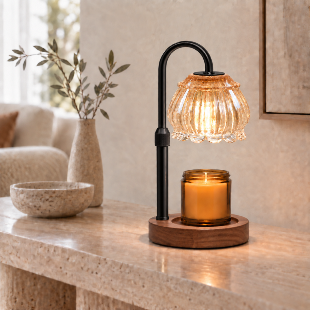 Champagne fluted glass candle warmer lamp with black arm on a neutral living room console