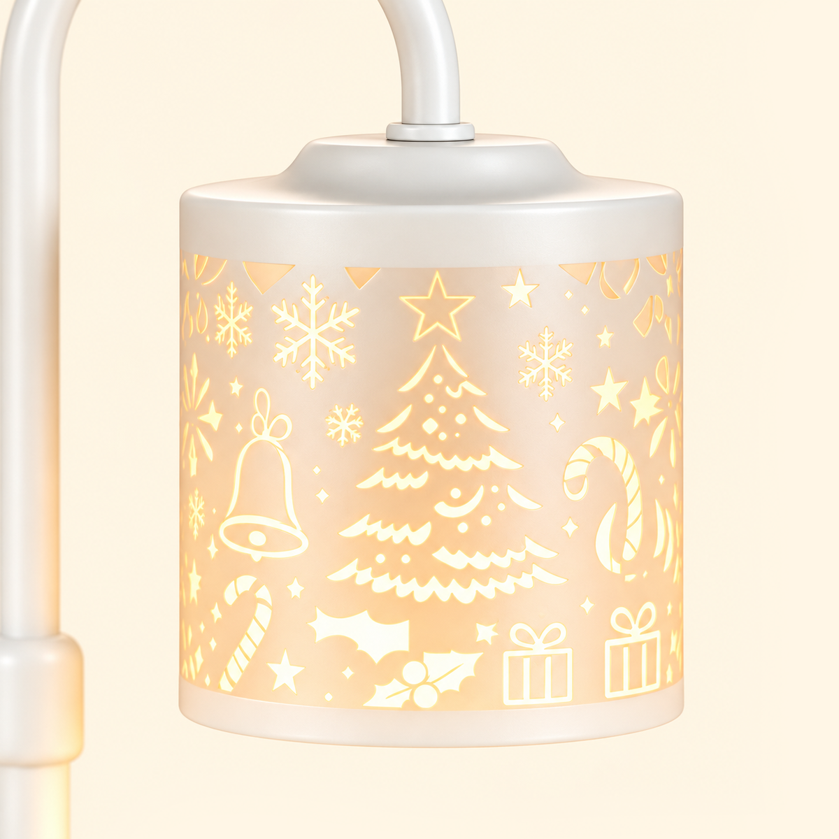 Close-up of a glowing white lampshade with Christmas tree, snowflake, bell, candy cane and gift motifs.