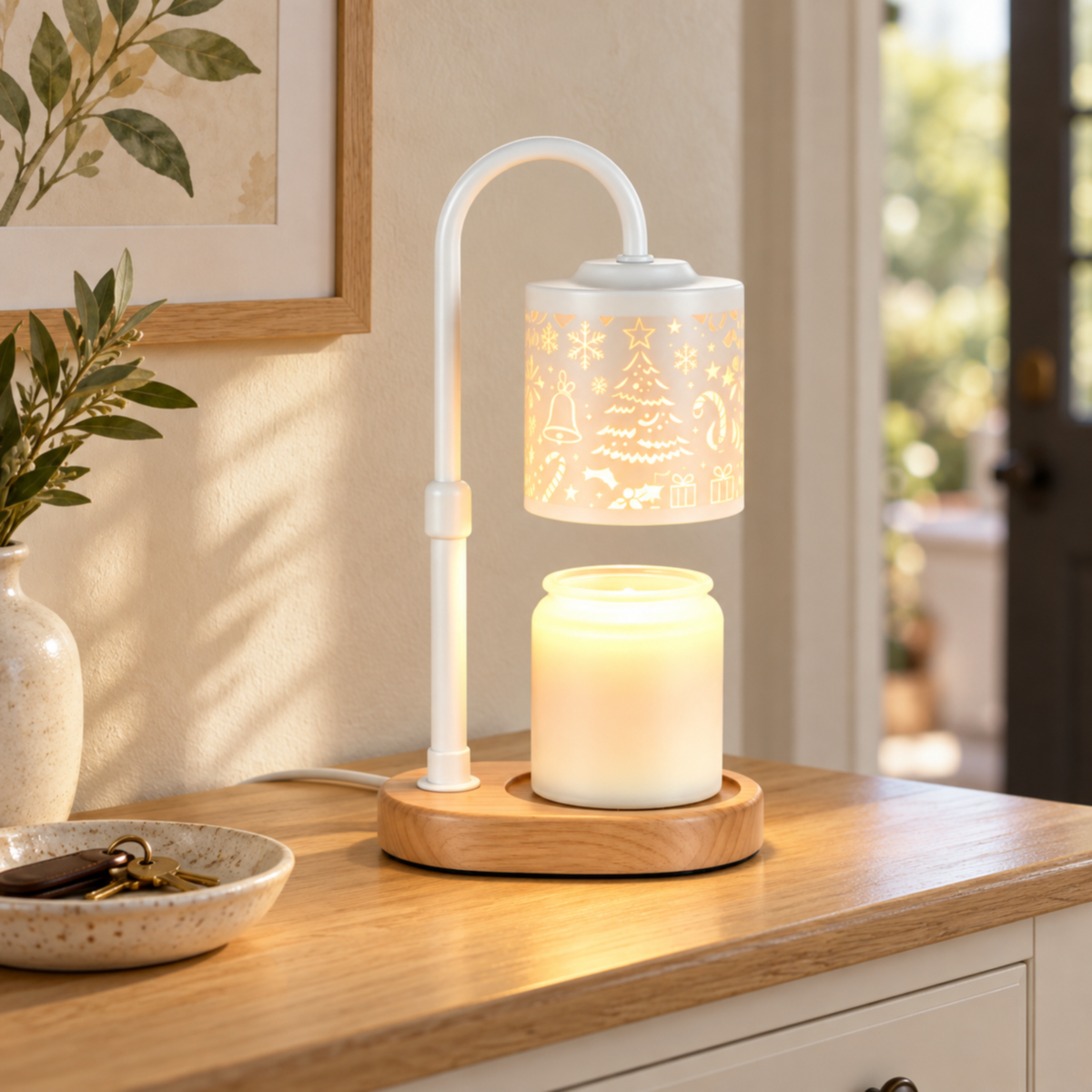 White Christmas candle warmer lamp with a wooden base on an entryway console beside a ceramic key dish.