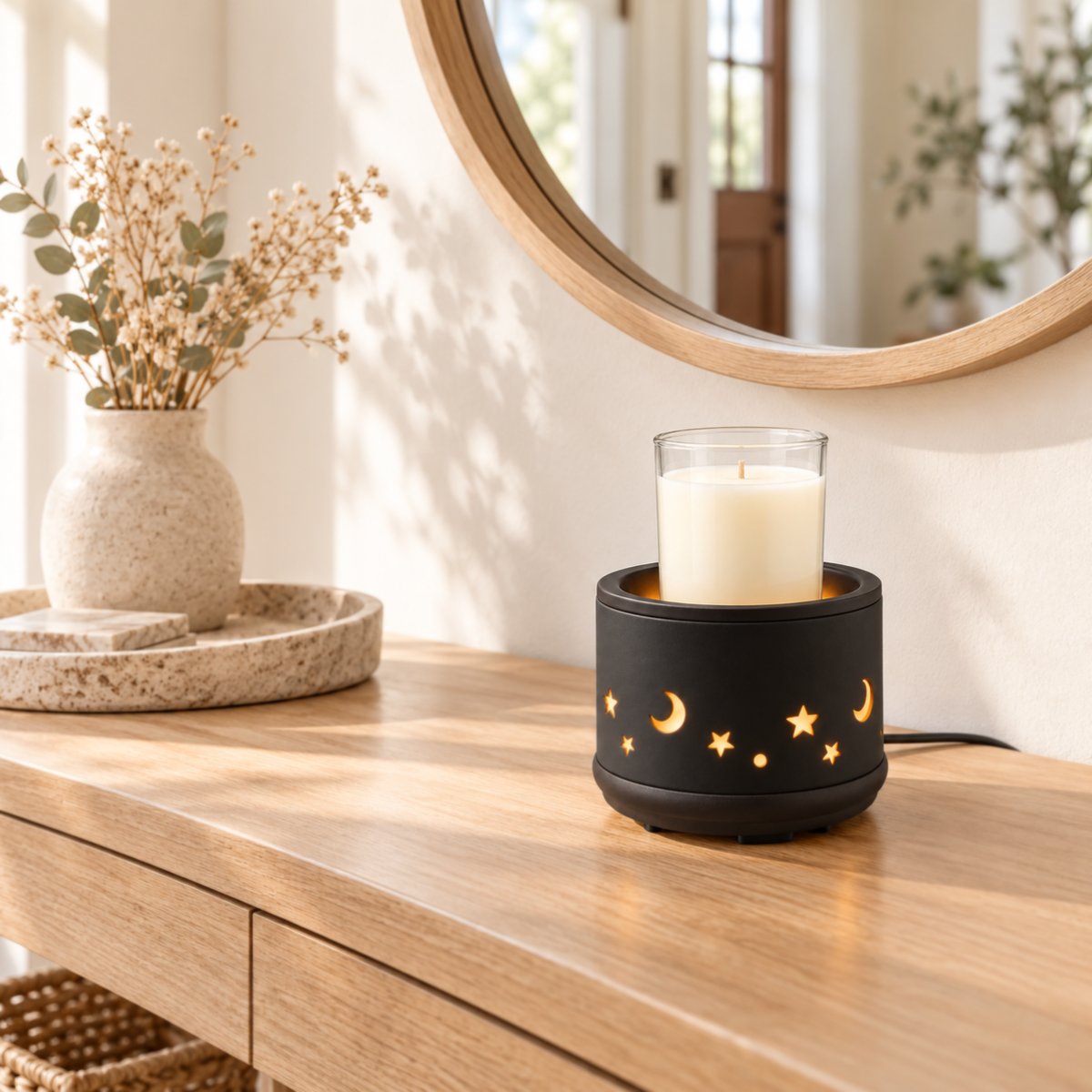 Black 2-in-1 warmer heating a clear glass jar candle on an entryway console in a bright home interior.