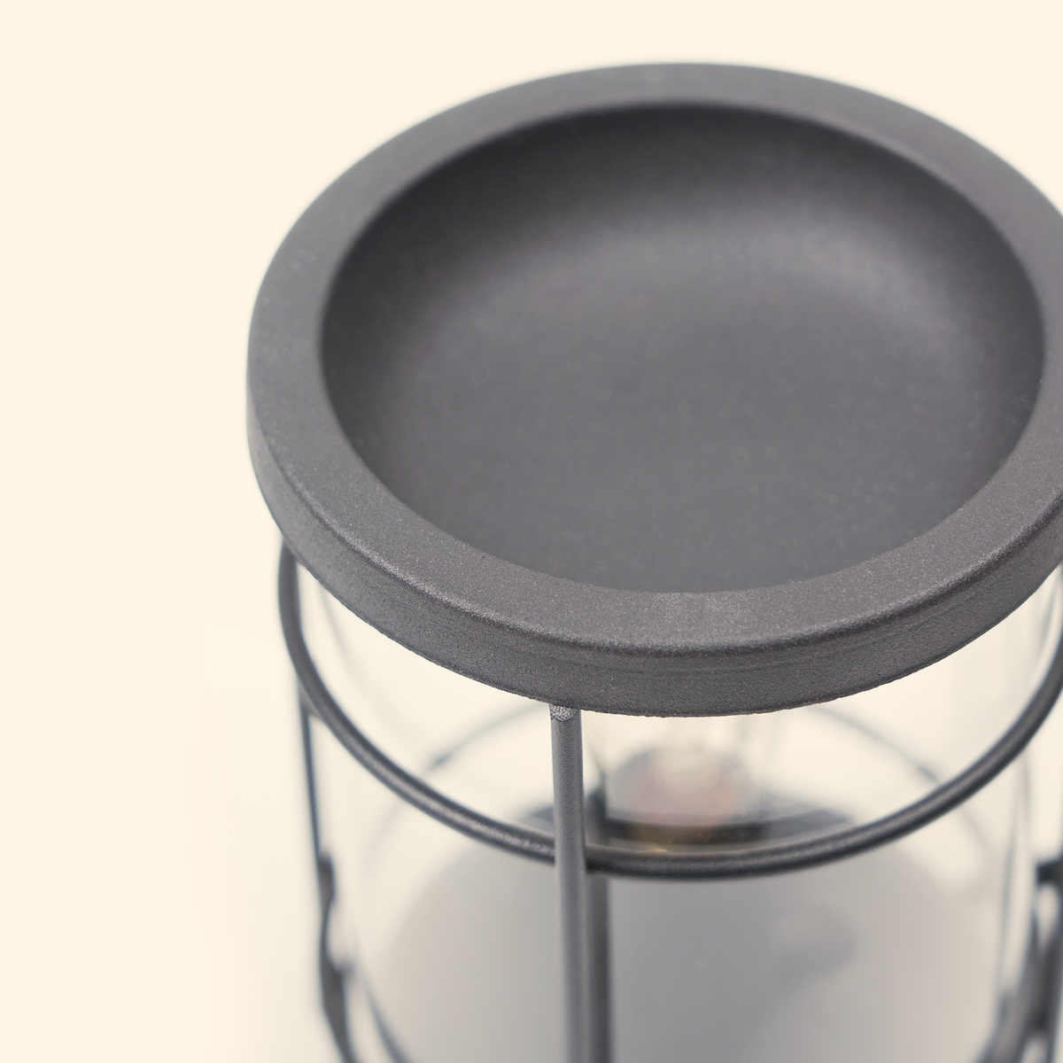 Top close-up of the black warming dish and metal frame on the unlit Vintage Lantern wax warmer.