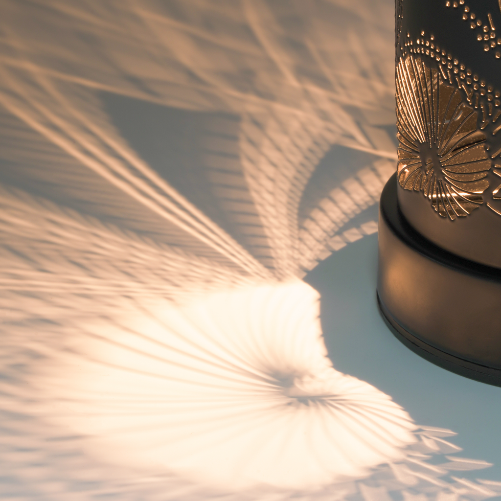 Close-up of the illuminated coastal cutout pattern casting detailed light and shadows.