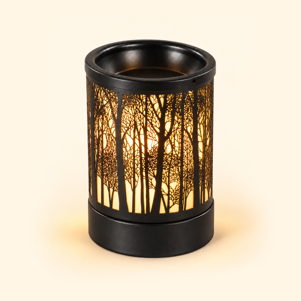 Forest Silhouette Metal Illumination Wax Warmer with warm amber light on a cream background