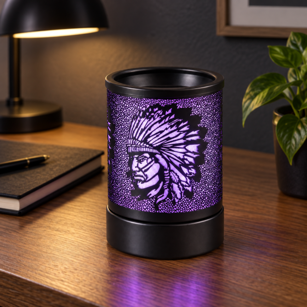 Purple glowing wax warmer with a feathered headdress design displayed on a home office desk.