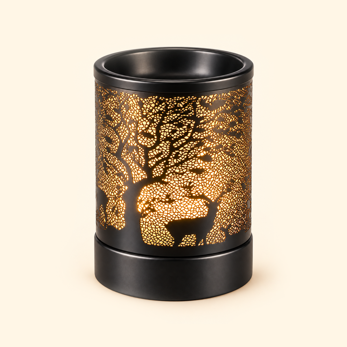 Black deer and tree electric wax warmer glowing amber on a warm ivory background.