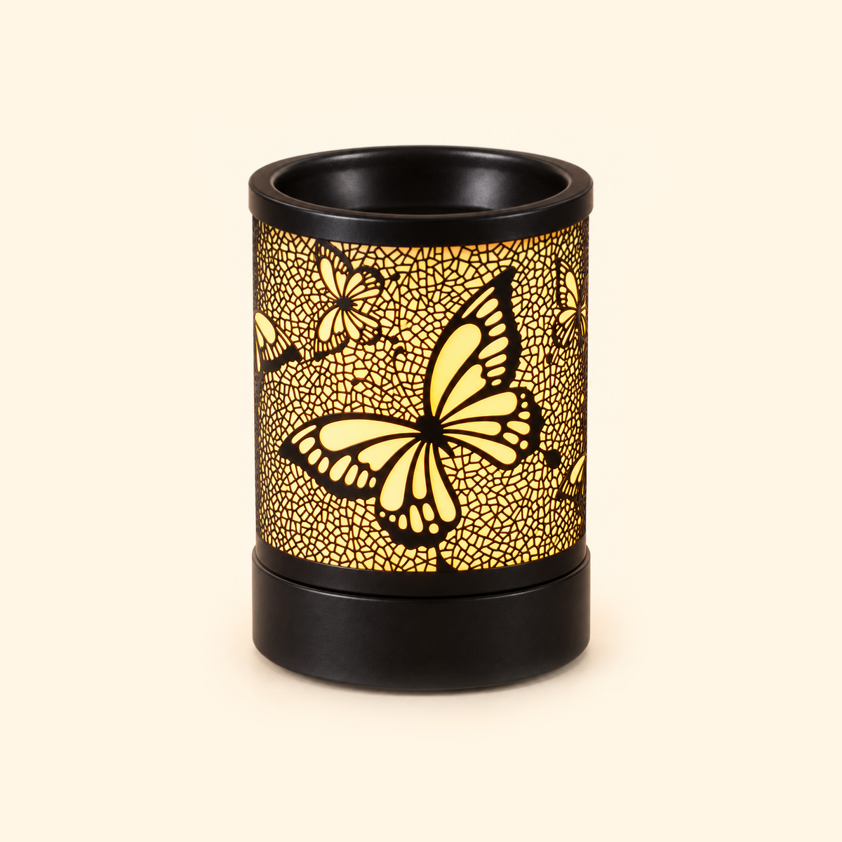Black butterfly electric wax warmer glowing brightly against a warm cream background.