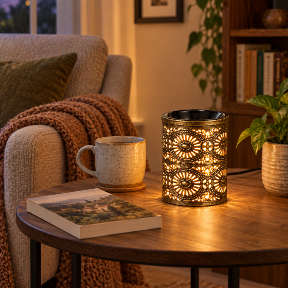 Glowing vintage bronze wax warmer on a round side table beside a tea mug and book in a cozy reading corner.
