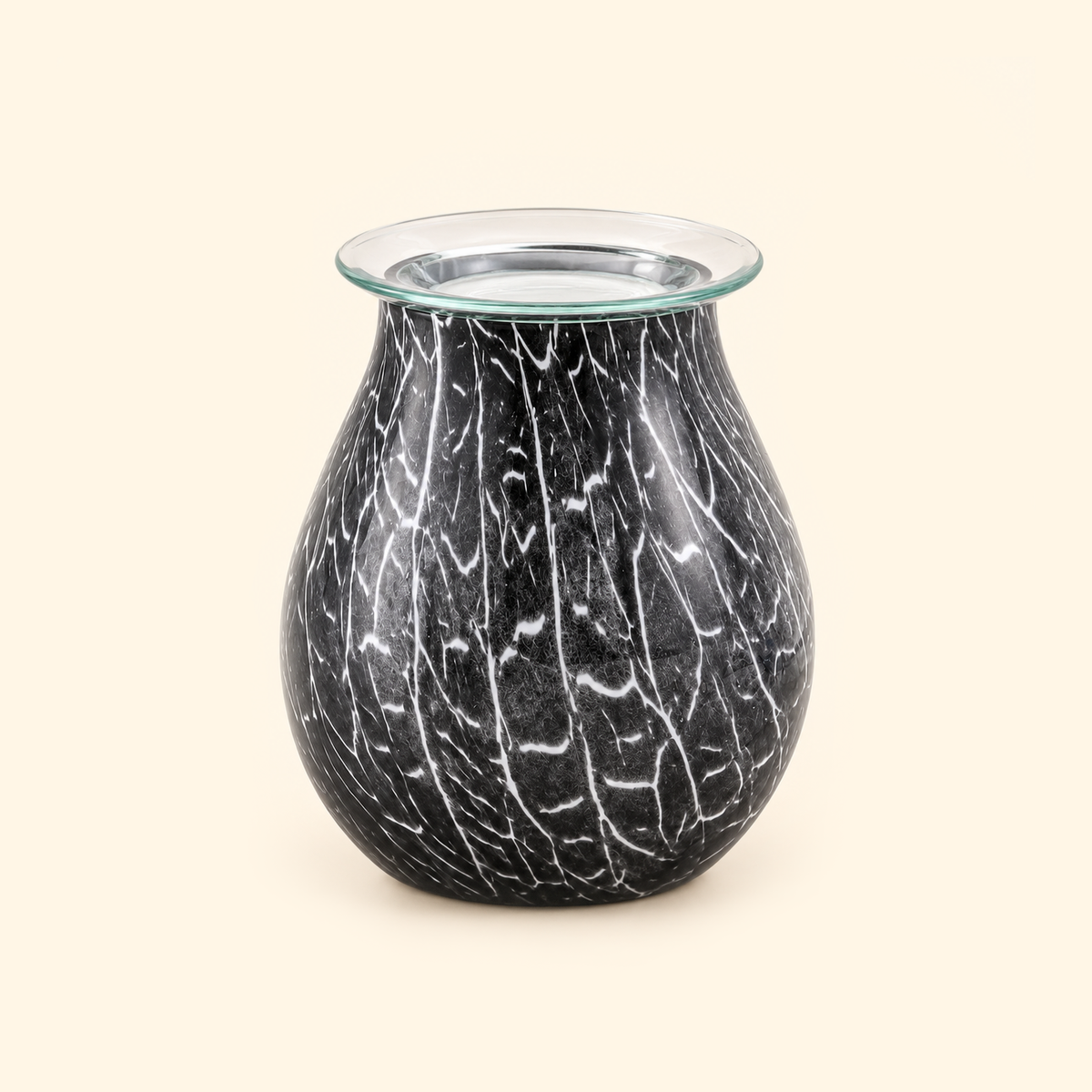Smoked Crackle Glass Illumination Wax Warmer switched off with a clear removable dish on a warm cream background.