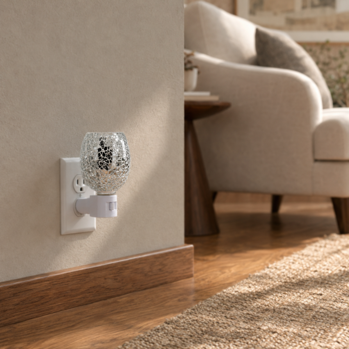 Clear crystal mosaic plug-in wax warmer displayed in a warm living room setting.
