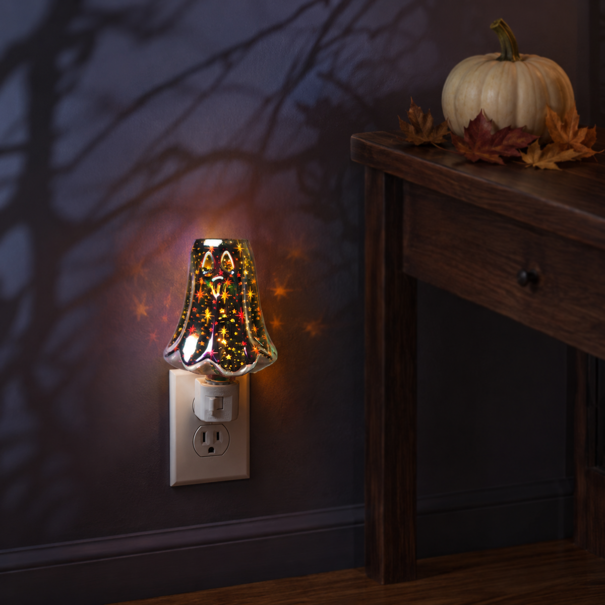 Halloween plug-in wax warmer glowing beside autumn decor in a dark seasonal interior.
