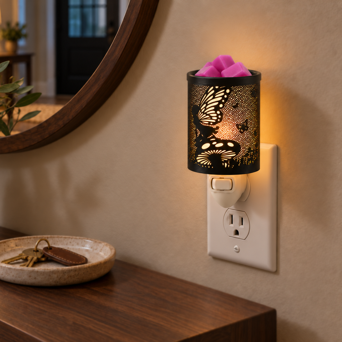Enchanted Fairy Garden plug-in wax warmer casting a warm glow beside a mirror and wooden console table.