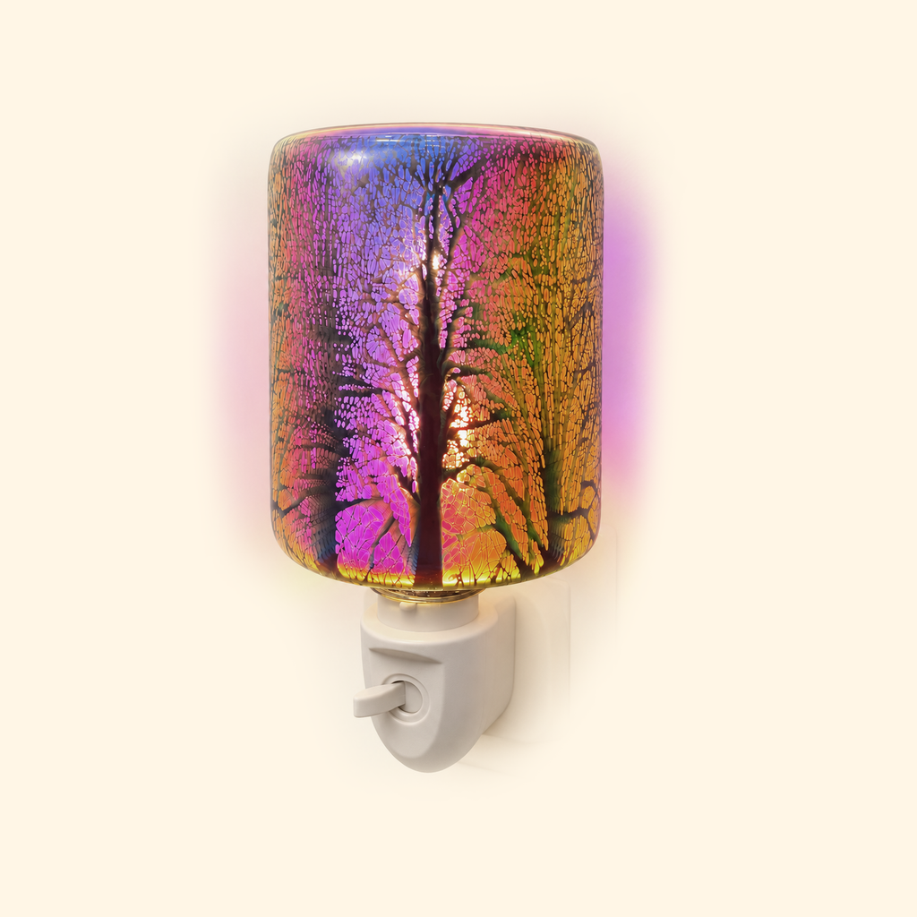 Angled view of the illuminated Galaxy Firework Pluggable Wax Warmer with forest silhouettes and crackle glass