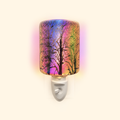 Front view of the Galaxy Firework Pluggable Wax Warmer glowing with multicolor light on a warm cream background