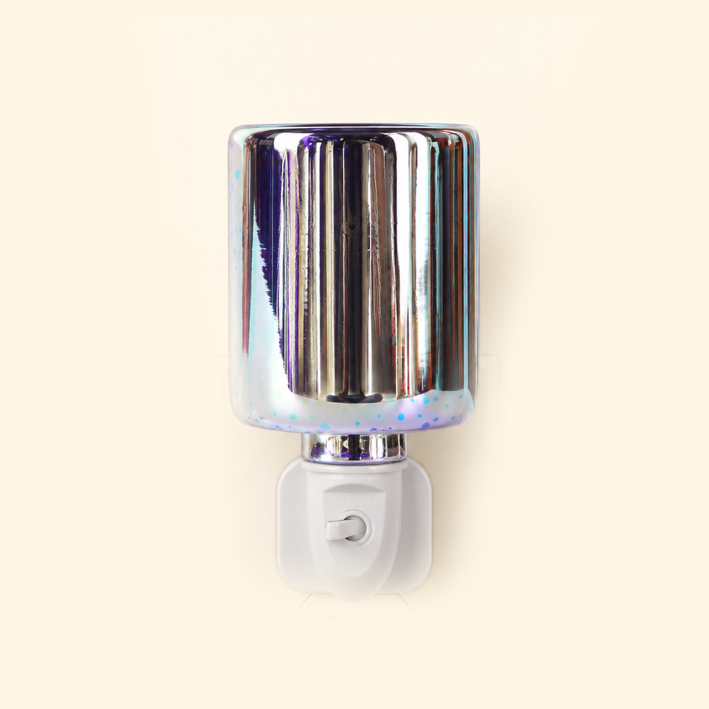 Iridescent firework glass pluggable wax warmer displayed unlit on a warm cream background