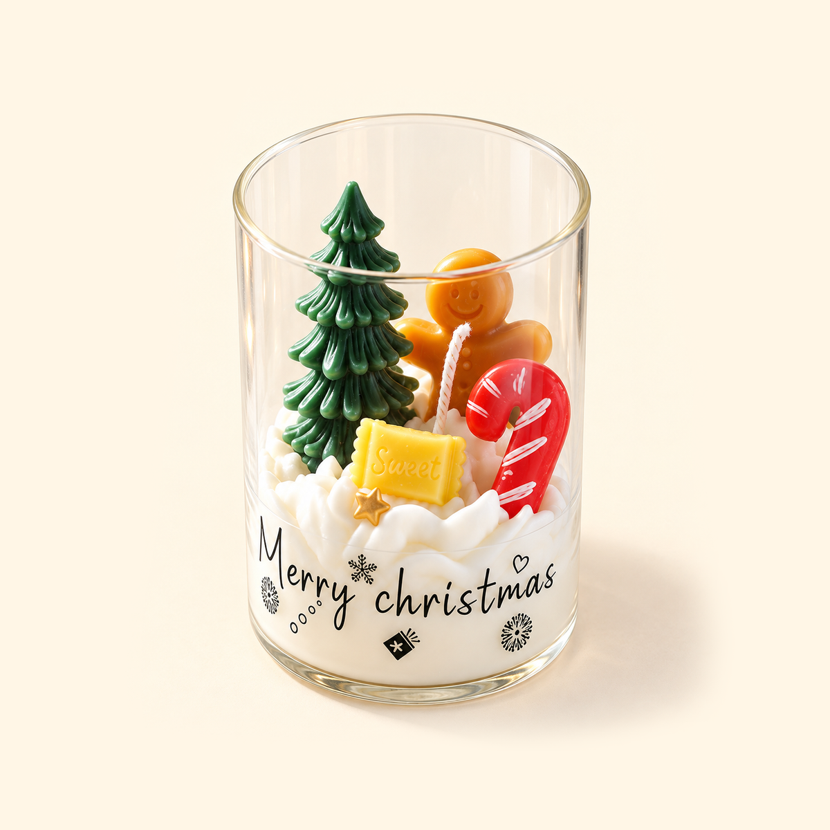 Angled top view of an open Christmas Night candle with a gingerbread man, candy cane and green tree in white wax.