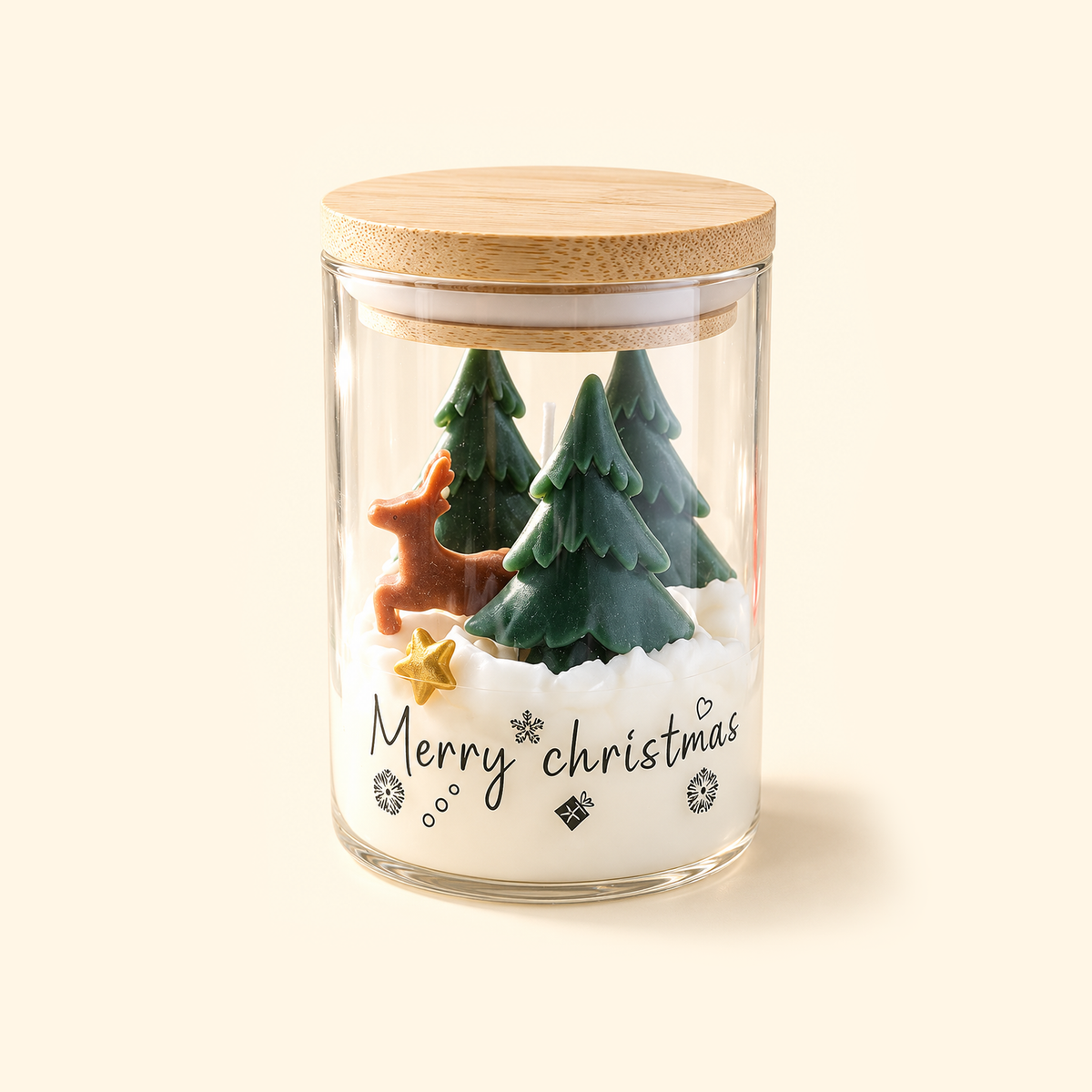 Christmas Woodland scented candle with a bamboo lid, brown deer and three green wax trees on a snowy white base.