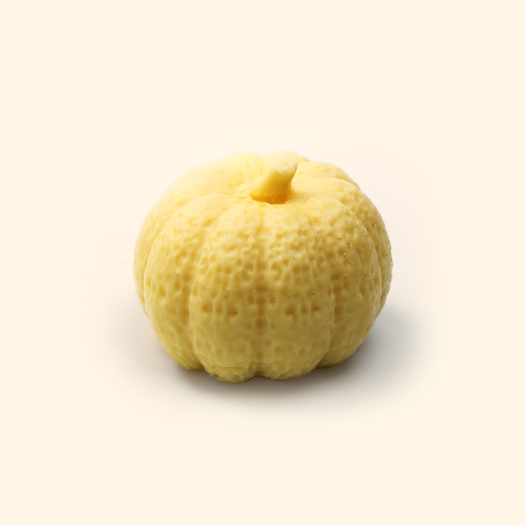 Halloween Pumpkin Silicone Wax Melt Mold Medium shown with a sample finished pumpkin wax piece featuring a rounded ribbed shape and short stem.