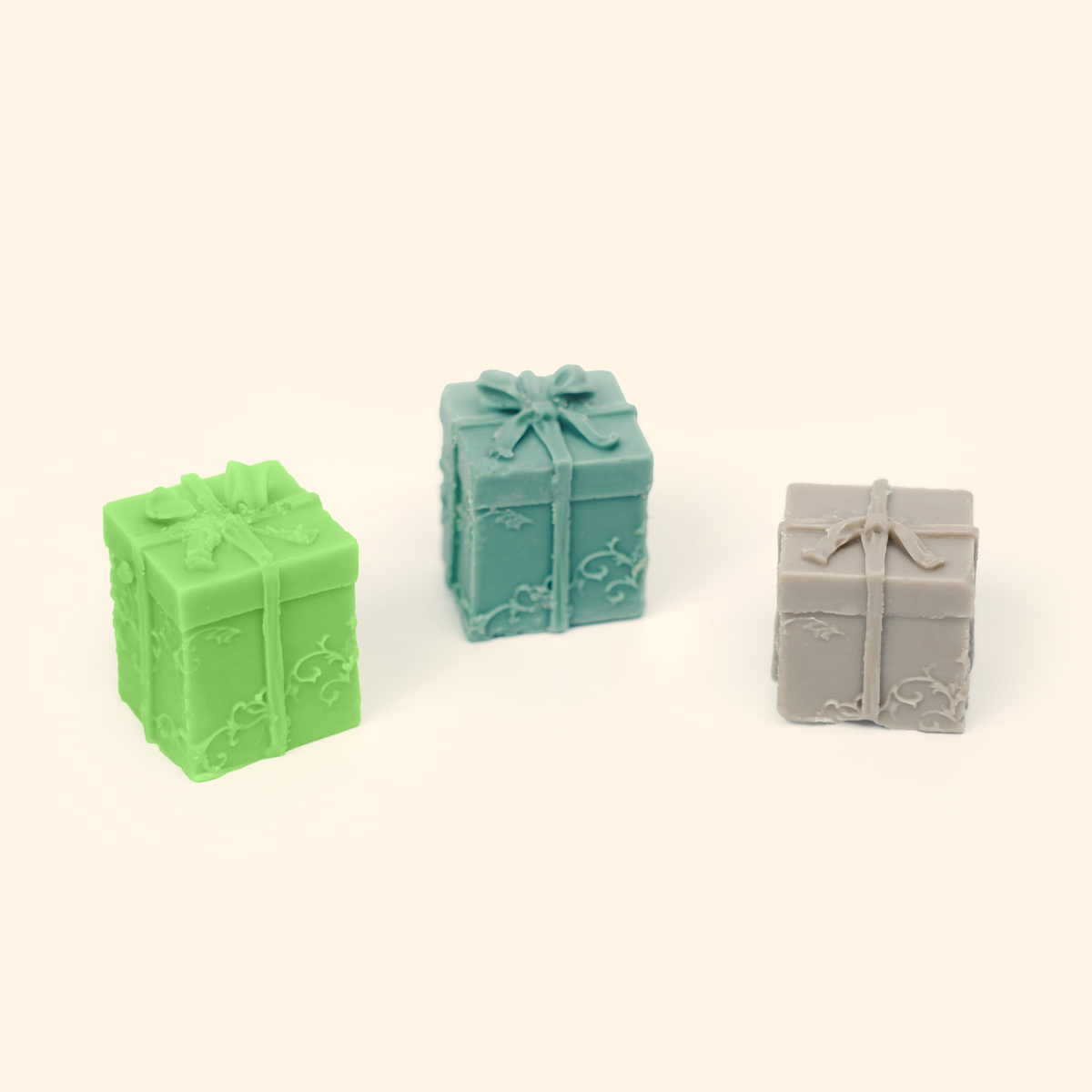 Gift Box Silicone Wax Melt Mold shown with sample finished gift box wax pieces featuring raised bows and ribbon details.