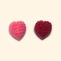 Embossed Rose Heart Silicone Wax Melt Mold shown with sample heart-shaped wax pieces featuring raised rose details.