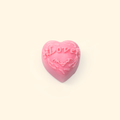 Embossed LOVE Heart Silicone Wax Melt Mold shown with a sample heart-shaped wax piece featuring raised LOVE lettering and floral details.