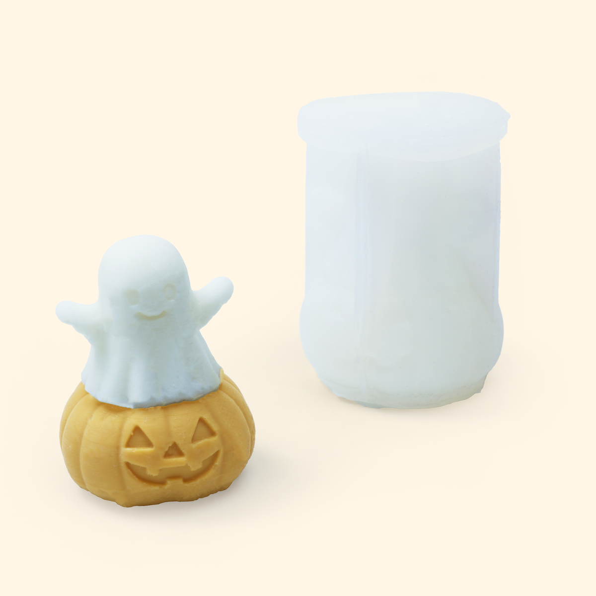 Translucent silicone Ghost Pumpkin mold displayed beside a sample finished wax piece showing the sculpted Halloween design.