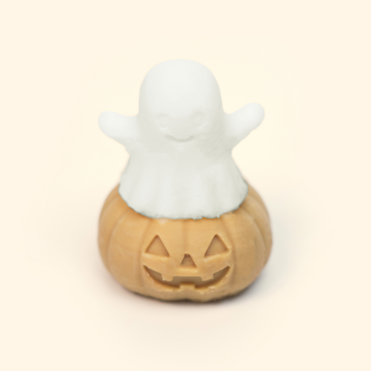 Ghost Pumpkin Silicone Wax Melt Mold shown with a sample finished wax piece featuring a ghost rising from a smiling jack-o’-lantern.