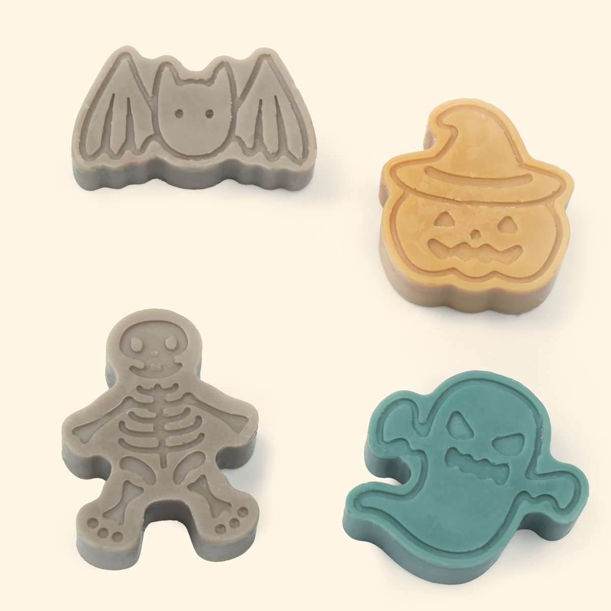 Halloween Wax Melt Mold Set shown with sample finished bat, jack-o’-lantern, skeleton and ghost wax shapes.
