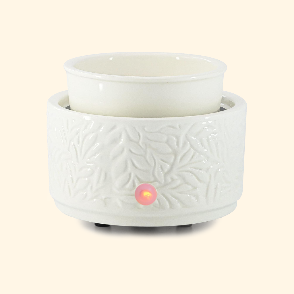 Front view of the Ivory Botanical ceramic wax warmer with empty dish and illuminated control indicator.