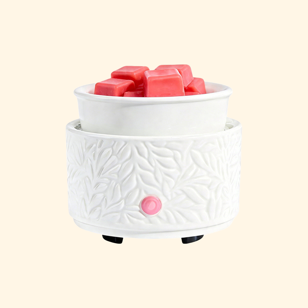 Ivory Botanical Ceramic Electric Wax Warmer with embossed leaf design and pink wax melts, front view.