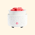 Ivory Botanical Ceramic Electric Wax Warmer with embossed leaf design and pink wax melts, front view.