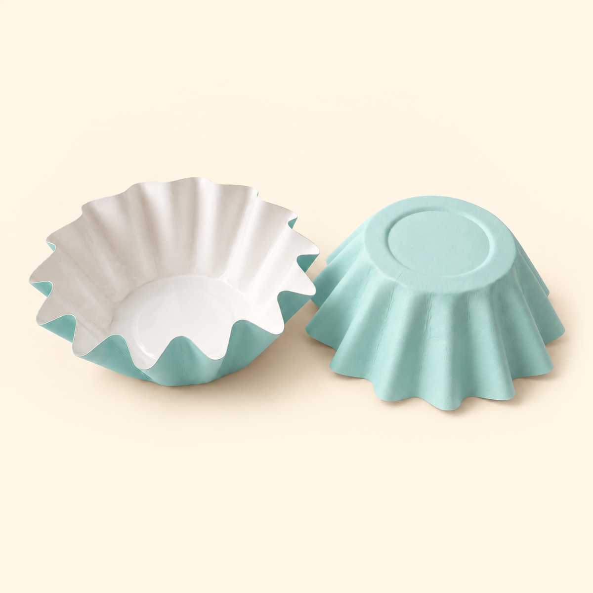 Mint blue disposable wax melt liners with white interiors, shown open and upside down on a warm ivory background