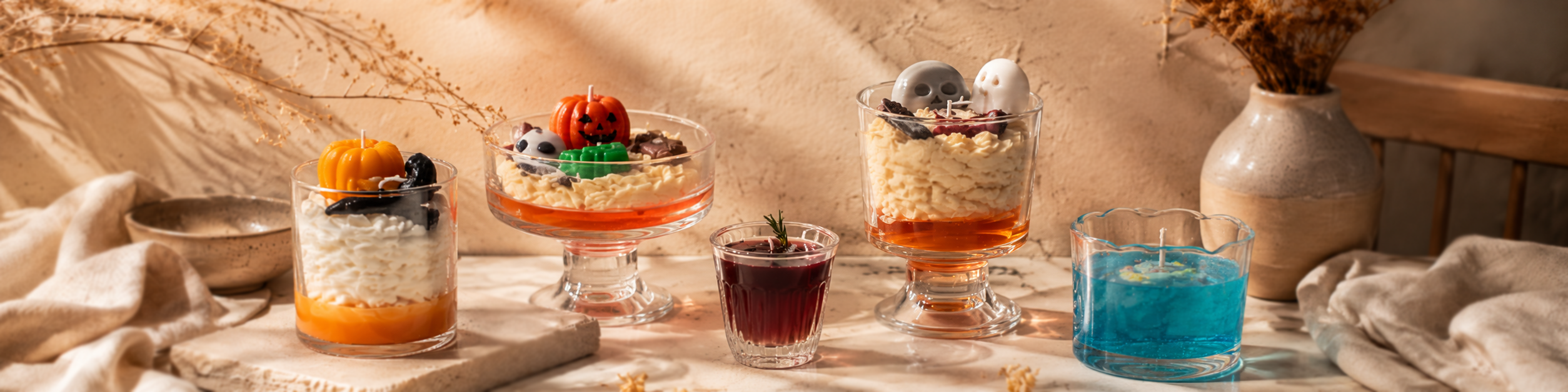Scented Candles collection featuring Pumpkin & Bat, Mischievous Pumpkin, Iced Americano, Little Ghost’s Party and Ocean Dream decorative candles in a warm neutral setting.