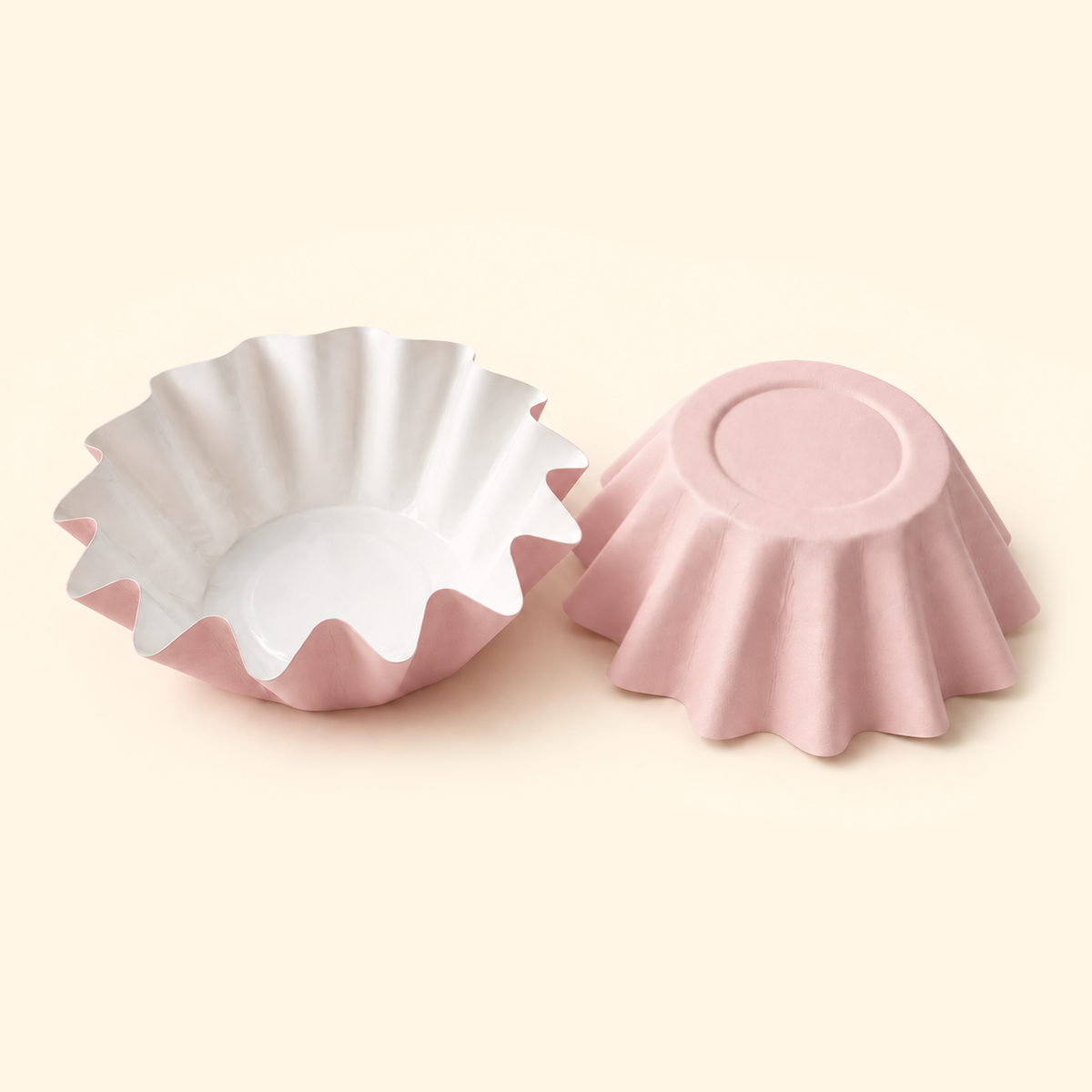 Blush pink disposable wax melt liners with white interiors, shown open and upside down on a warm ivory background